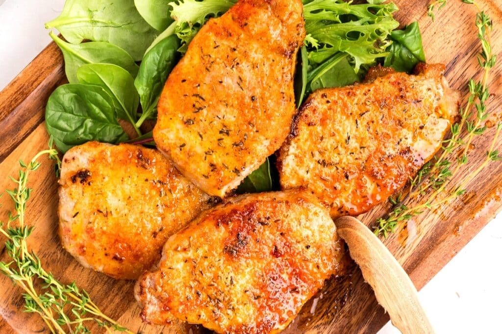 Perfect pork chops on a wooden board.