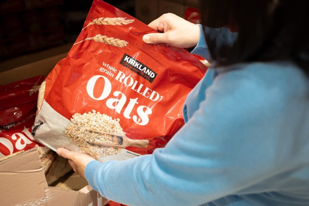 Holding a pack of rolled oats.