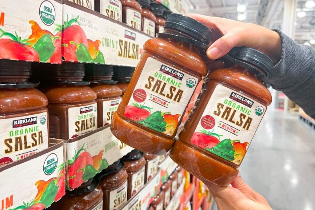 Holding a jar of salsa from store shelves.