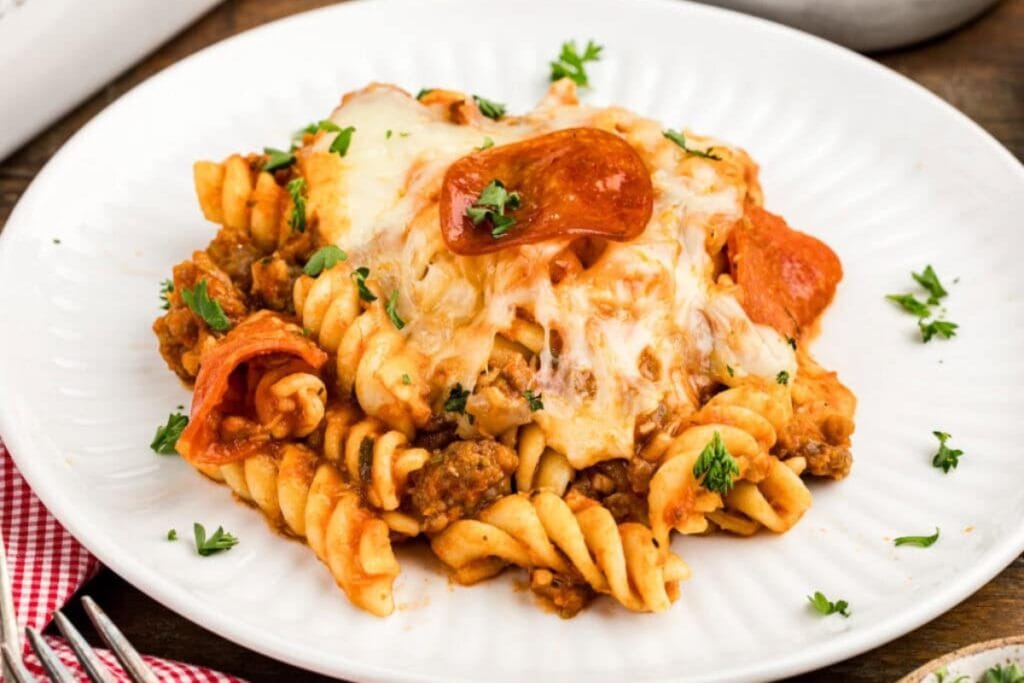 Sausage and pepperoni pizza casserole on a plate.