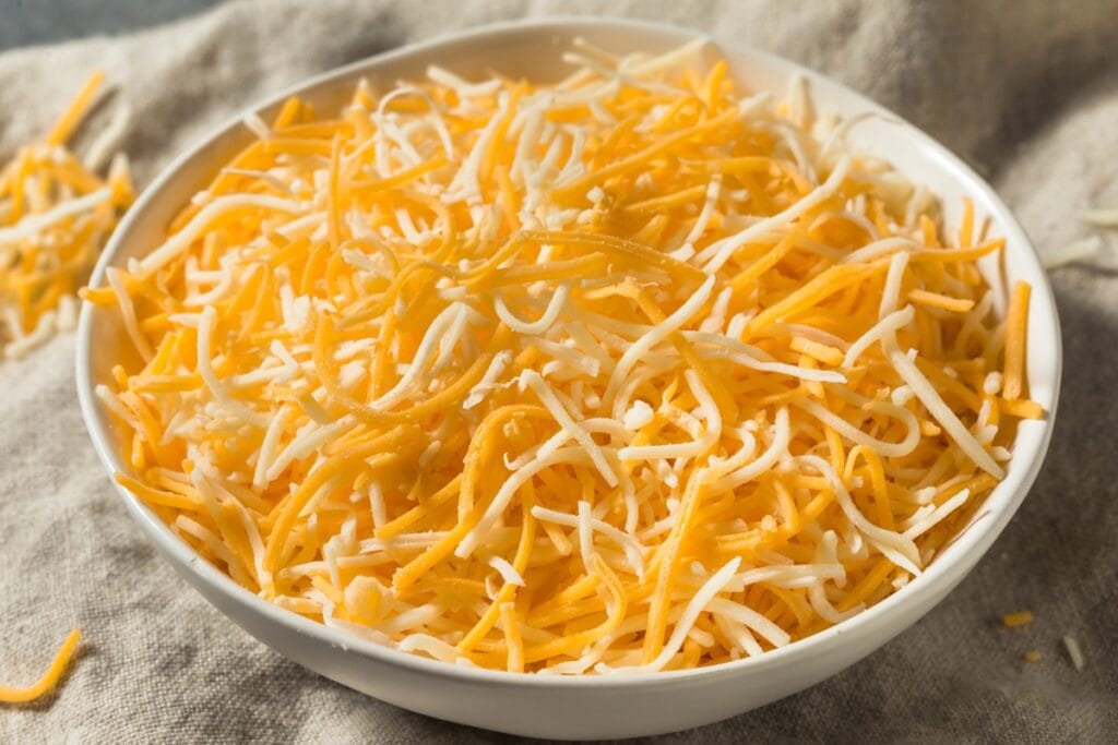 Shredded cheese in a bowl.
