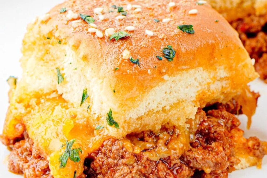 Close-up of Sloppy Joe sliders with Hawaiian rolls filled with saucy ground beef.