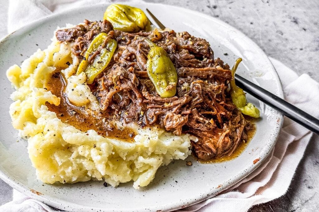 Mississippi pot roast with mashed potatoes on a plate.