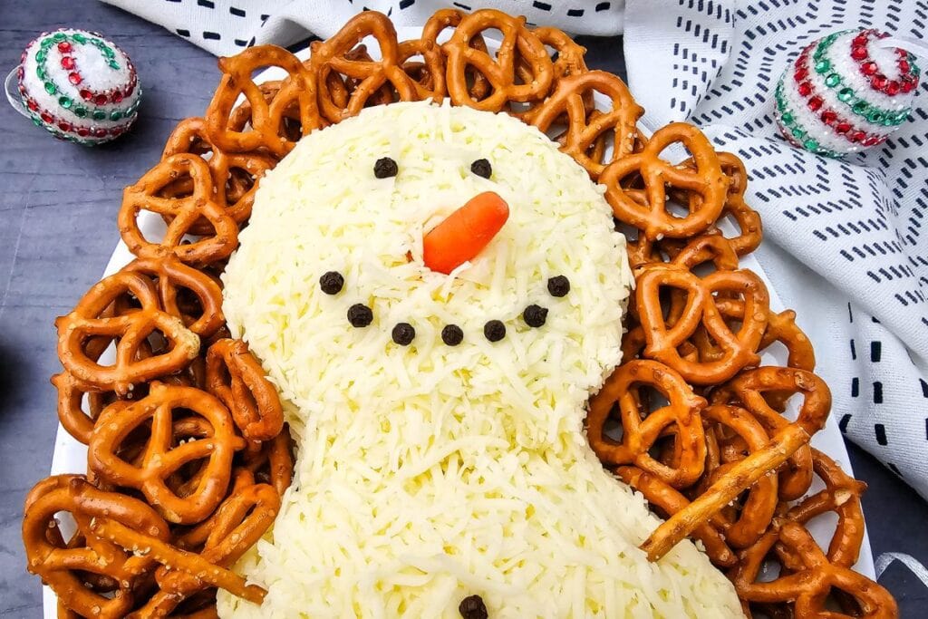A close up shot of snowman cheeseball.