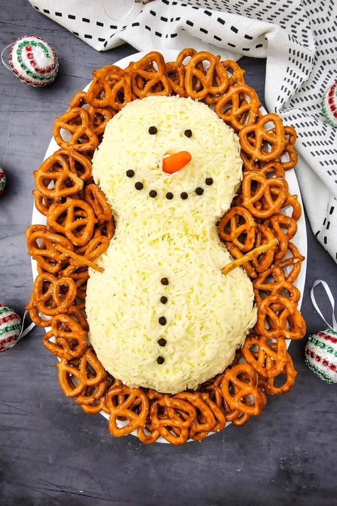 A close up shot of snowman cheeseball.