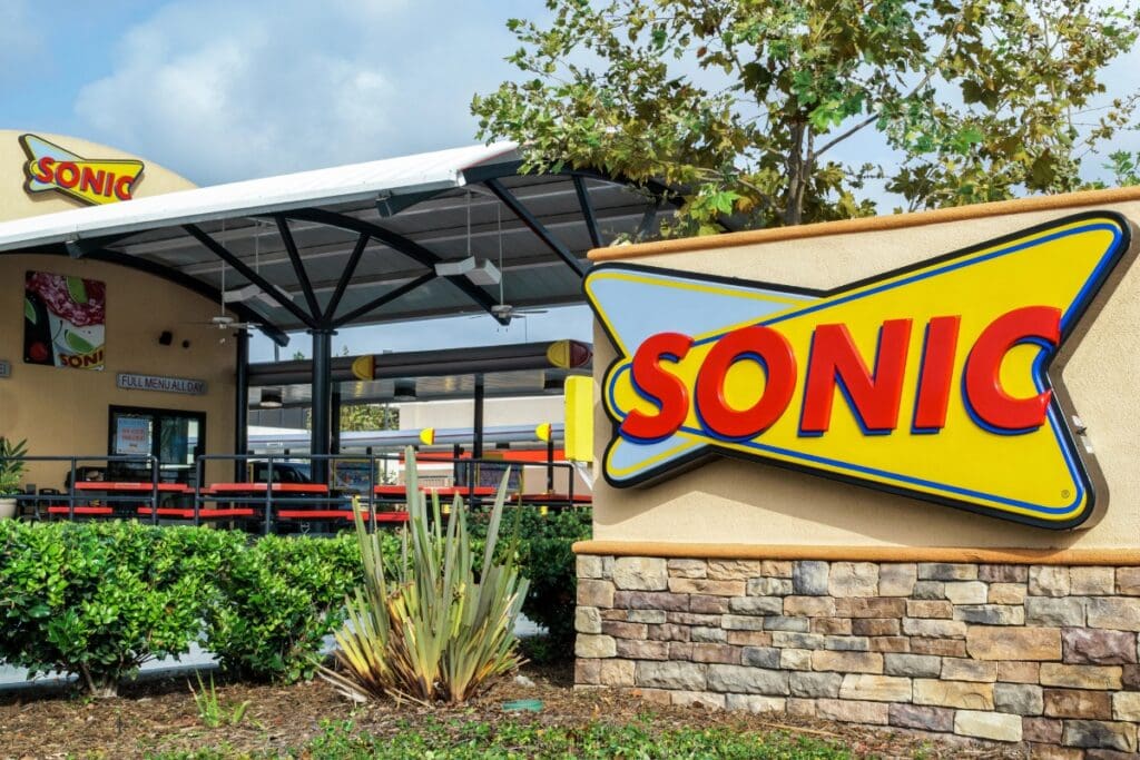 Sonic food chain restaurant perspective view with outdoor seating area.
