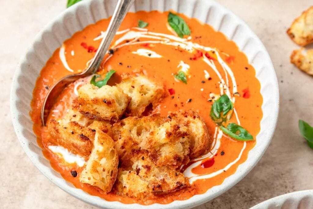 Spicy tomato soup in a white bowl.