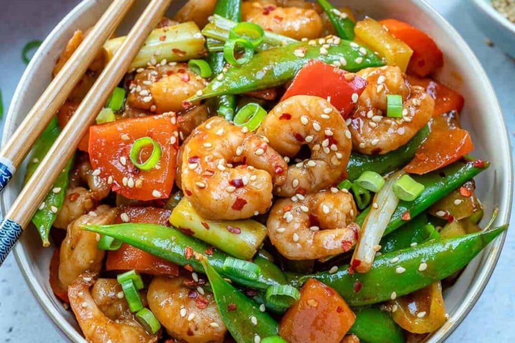 Szechuan shrimp stir fry with vegetables in a bowl.