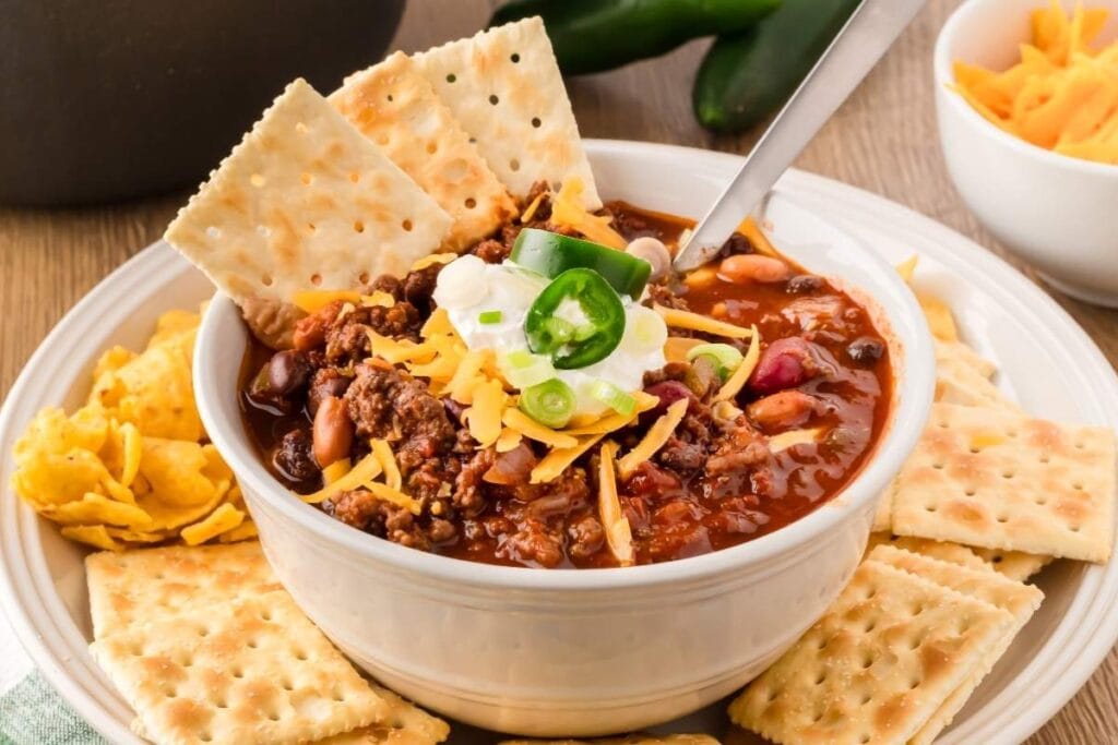 Venison chili in a bowl, served with crackers.
