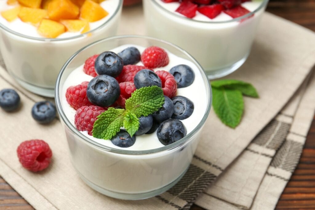 Yogurt cups topped with fresh berries.