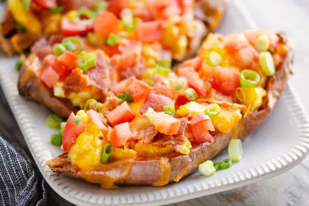 Sweet potato skins topped with cheese, tomatoes, bacon, and green onions.