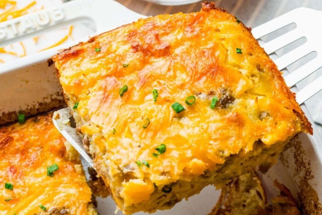 Slice of Bisquick breakfast casserole being lifted from the baking dish.