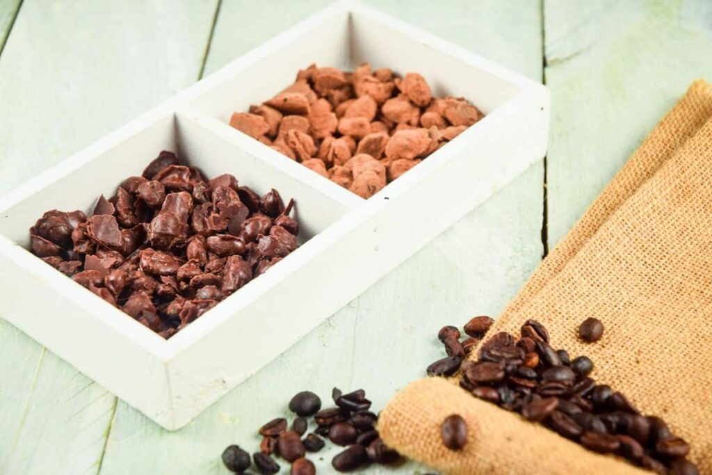 A close up shot of chocolate covered coffee beans.