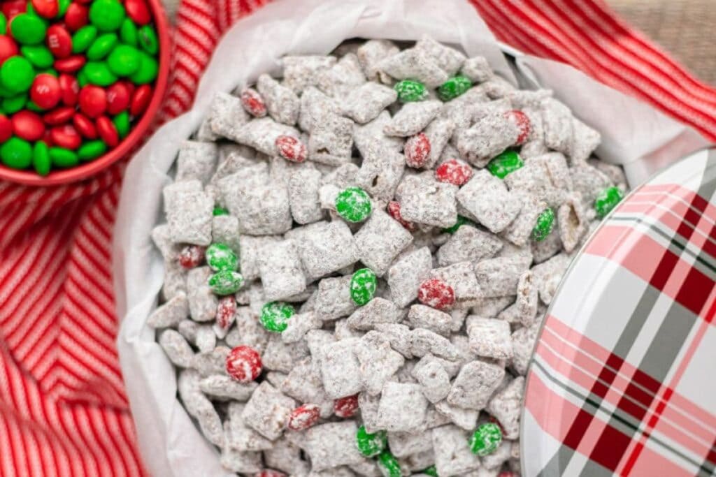 Christmas puppy chow in a bowl with red and green M&Ms.