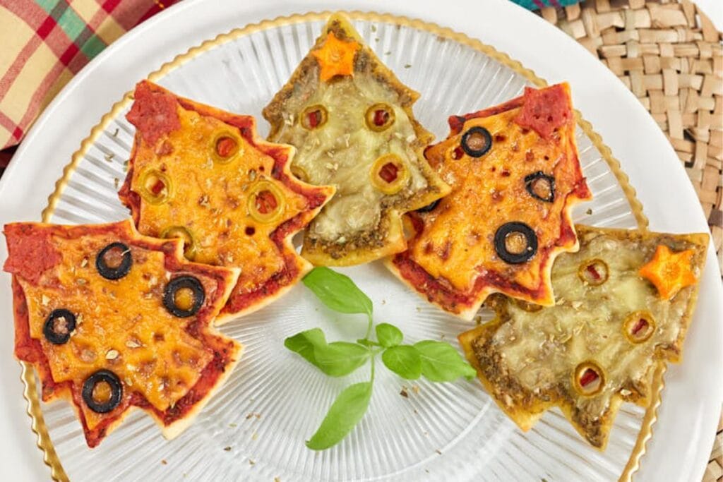 A close up shot of Christmas tree pizzas.