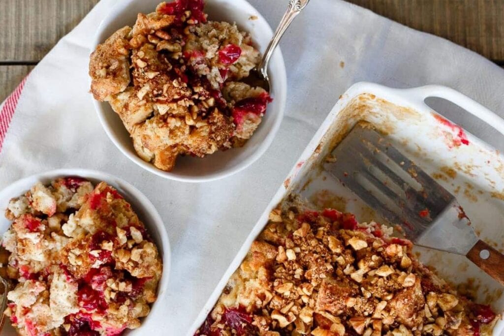 Cranberry mascarpone casserole in a baking dish and in two bowls.