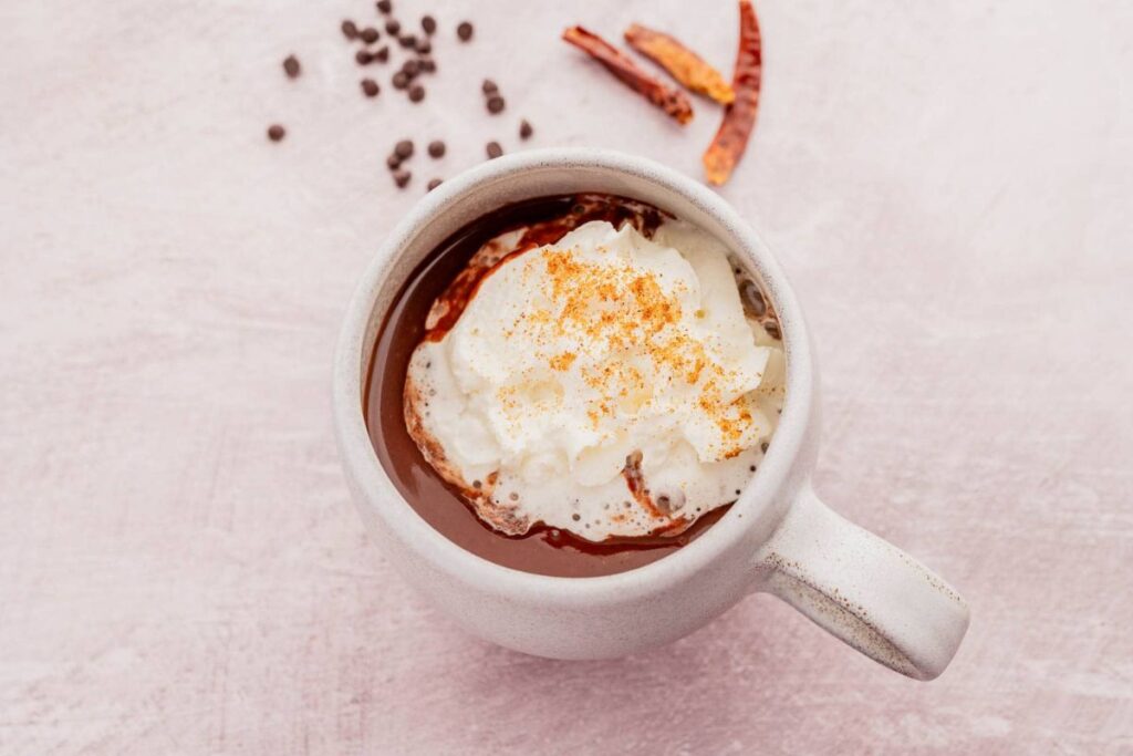 Hot chocolate with whipped cream and chili peppers.