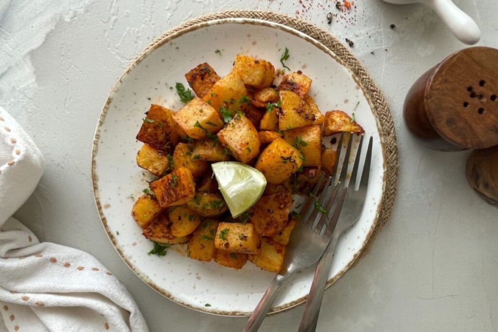 Mexican roasted potatoes with lime and parsley on a plate.
