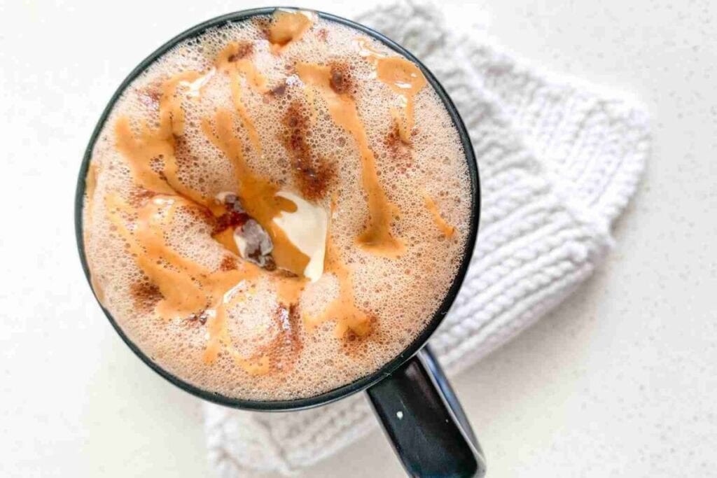 Overhead shot of peanut butter hot chocolate with caramel drizzle.