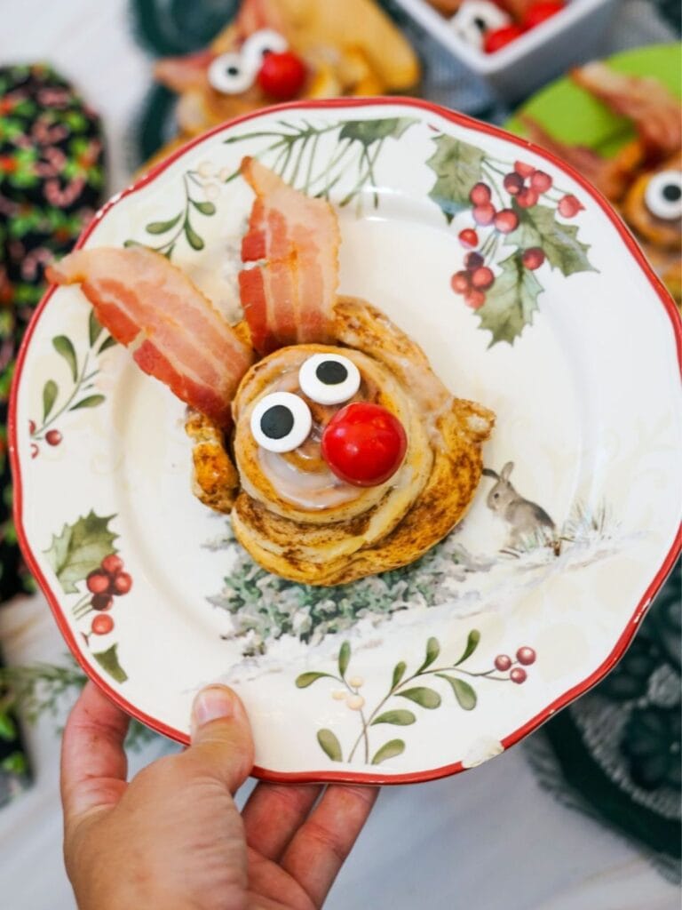 A close up shot of Reindeer cinnamon roll on a plate.