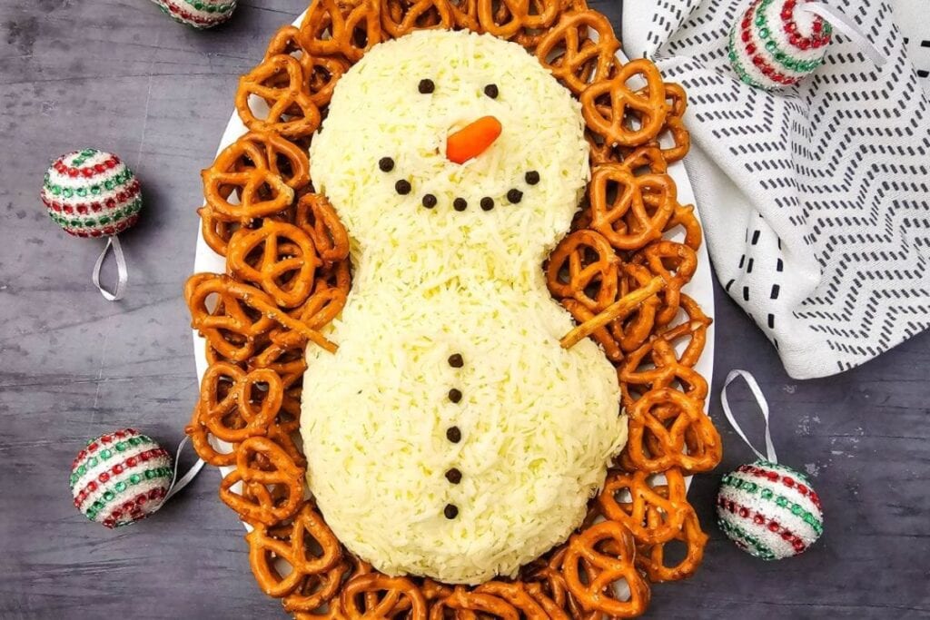 A close up shot of snowman cheeseball.