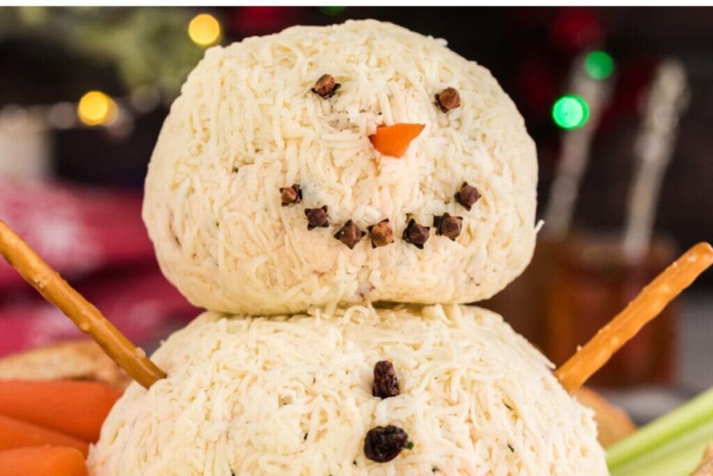 A close up shot of snowman cheeseball.