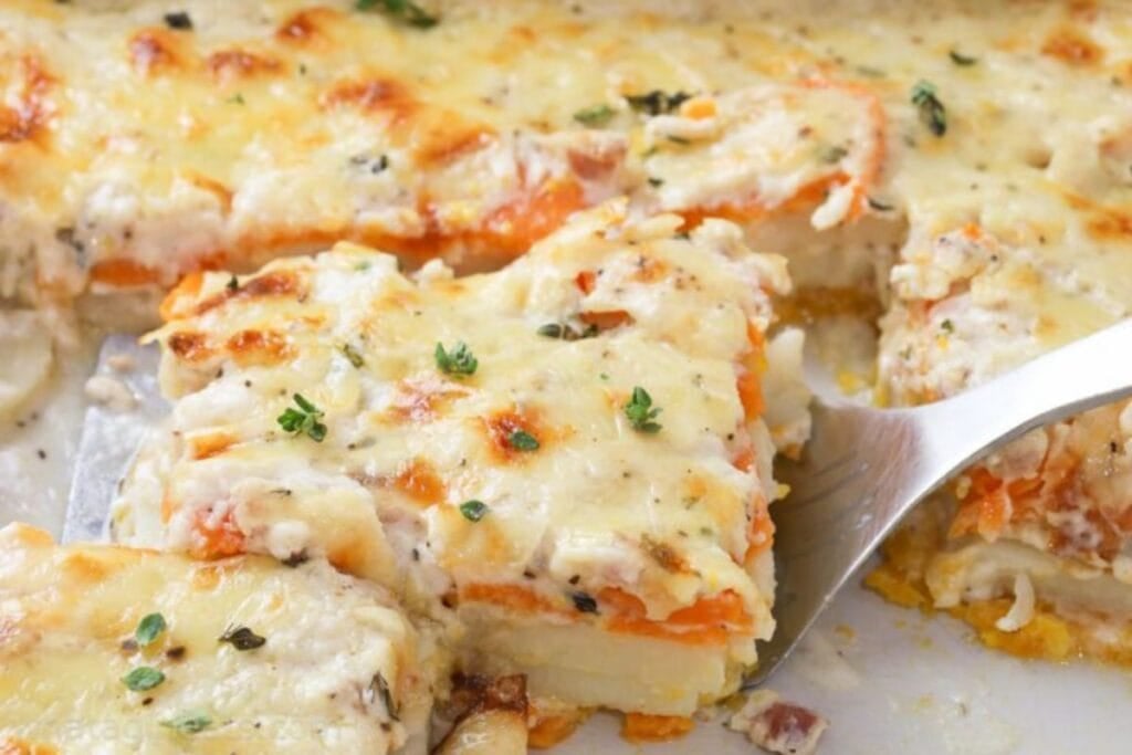 A slice of sweet potato gratin being lifted with a spatula.