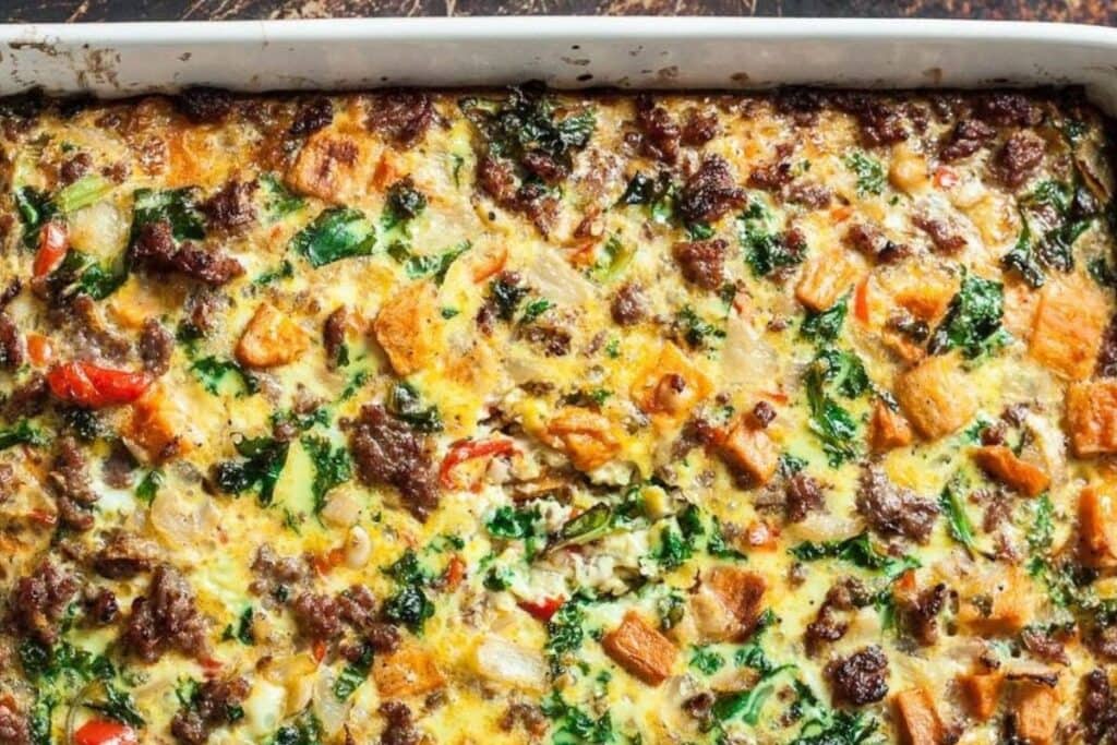 Overhead shot of a sausage and sweet potato breakfast casserole in a baking dish.