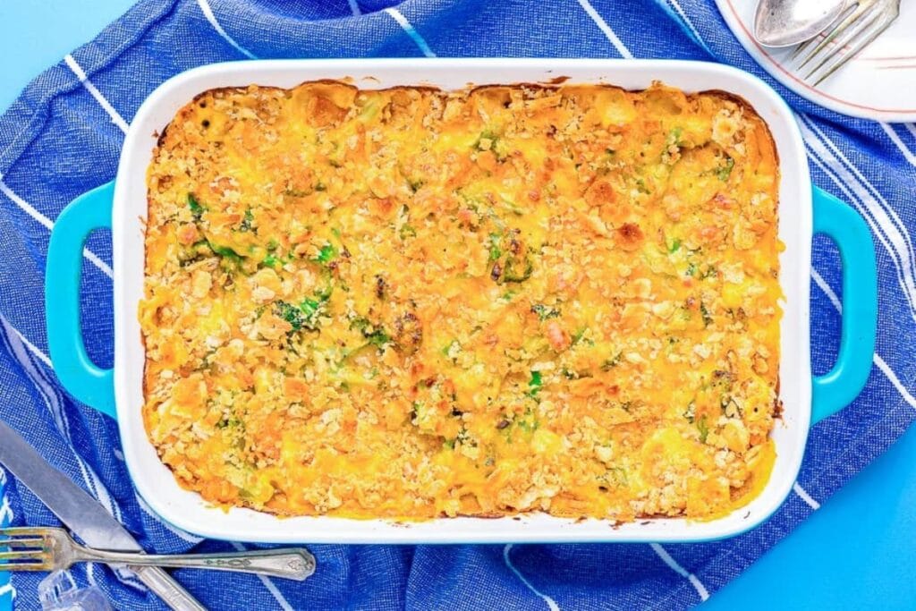 Broccoli casserole topped with Ritz crackers in a baking dish.