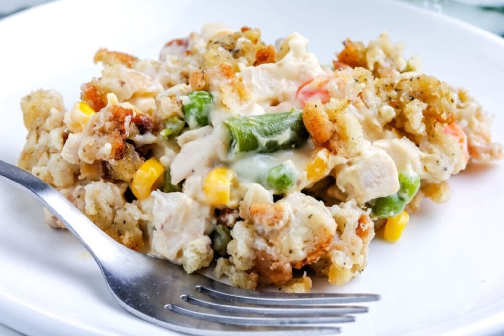 Chicken stuffing casserole on a plate with a fork on the side.