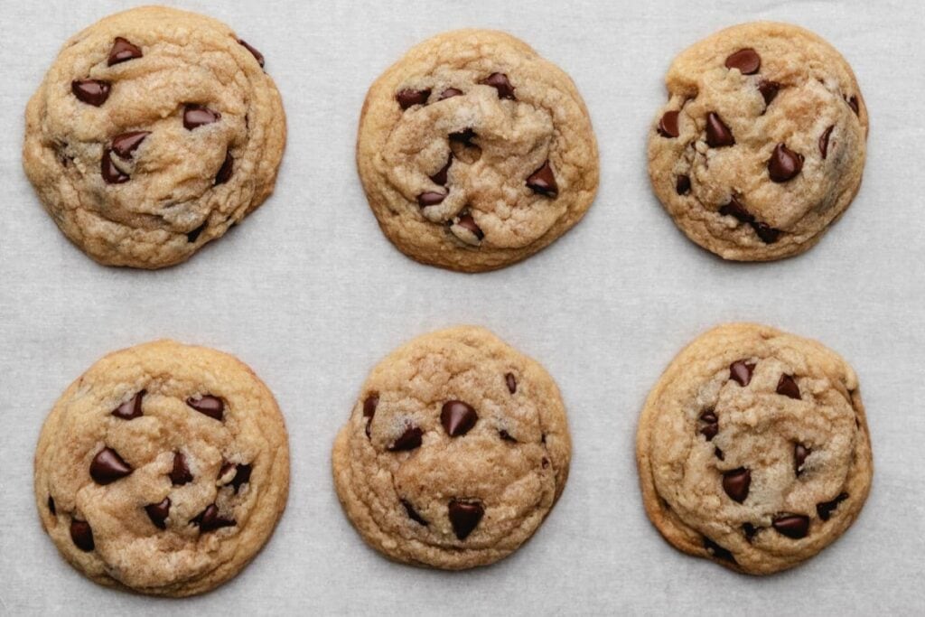 Chocolate chip cookies on parchment paper.