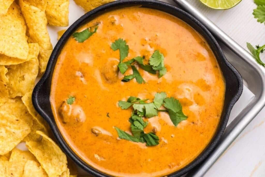 Copycat Chili’s queso served in a black bowl.