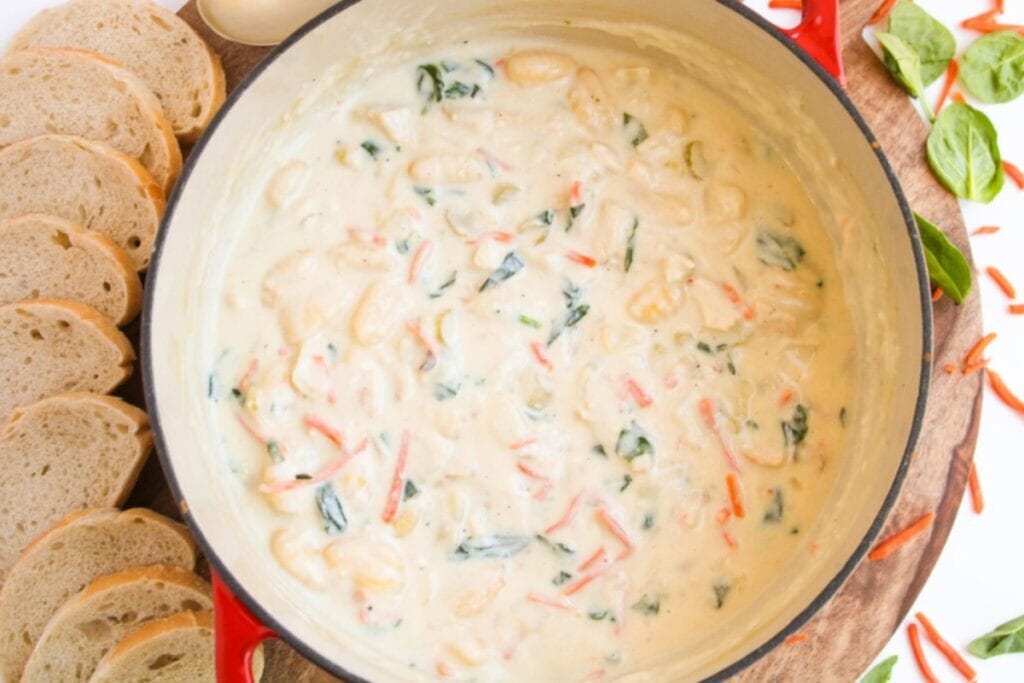 Creamy chicken and gnocchi soup in a pot.