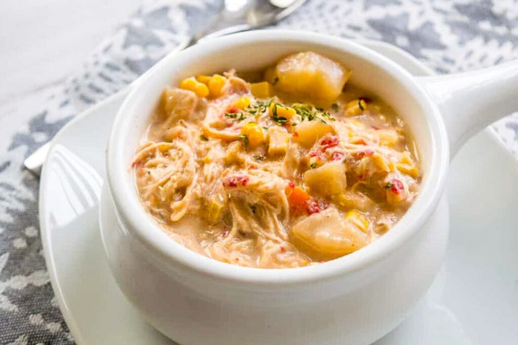 Creamy chicken corn chowder served in a white bowl.