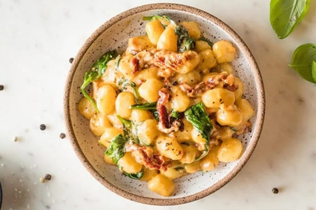 Creamy Tuscan gnocchi on a plate.
