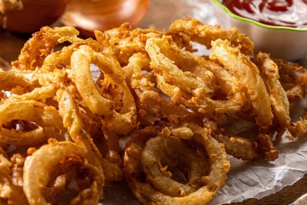 Crispy southern buttermilk onion rings on parchment paper.