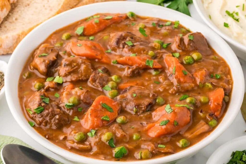 Crockpot beef stew served in a white bowl.