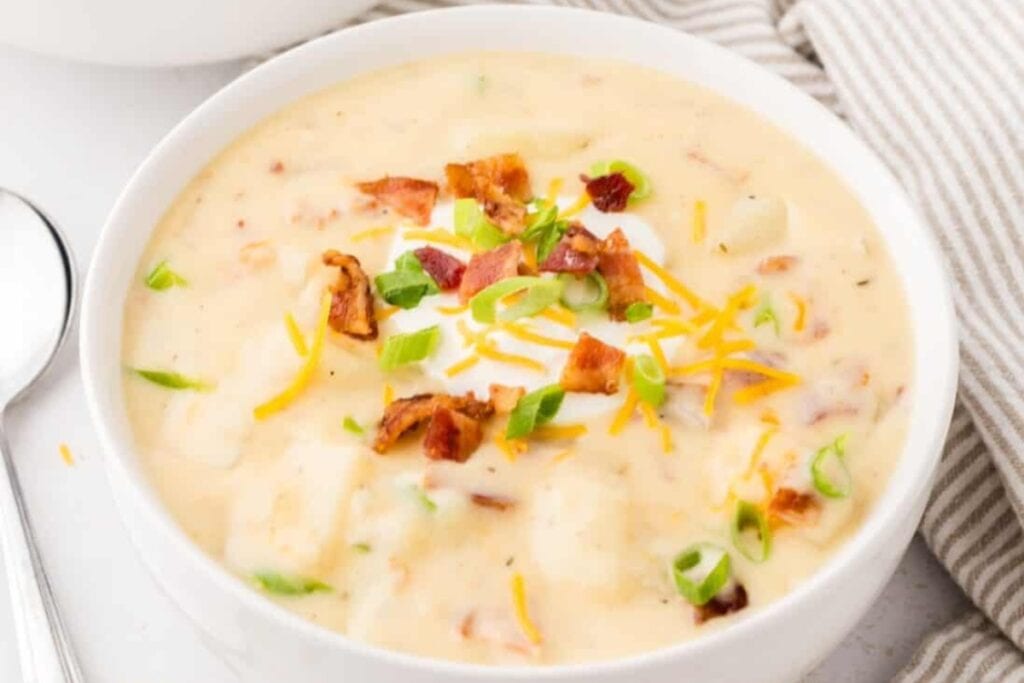 Crockpot potato soup served in a white bowl.