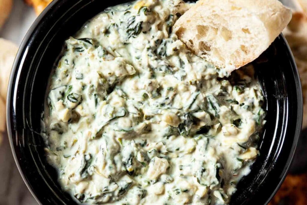 Spinach artichoke dip in a bowl.