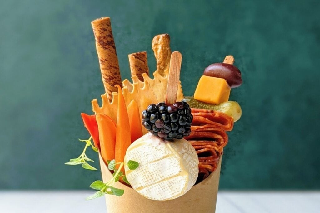 DIY charcuterie cups with meats, cheeses, and snacks.