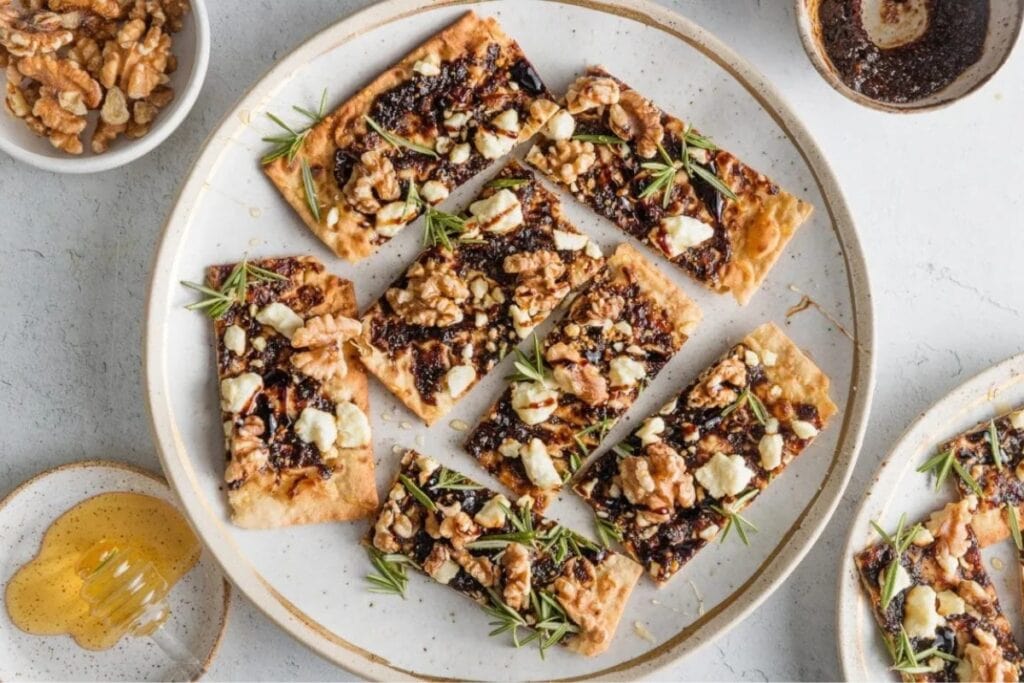 Fig, balsamic, and walnut flatbreads on a plate.