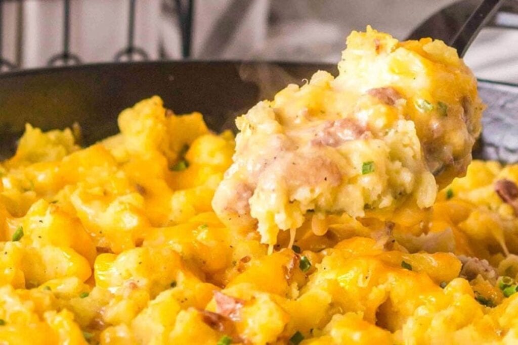 Hamburger potato casserole scooped from a skillet.