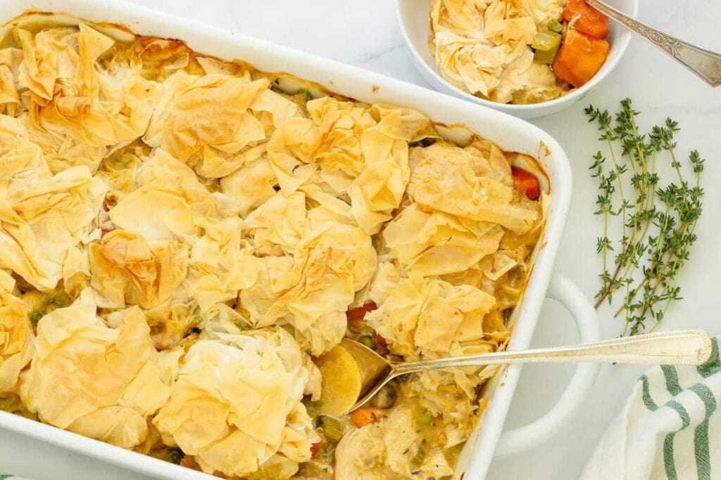 Chicken potpie with mushrooms and leeks in a baking dish.
