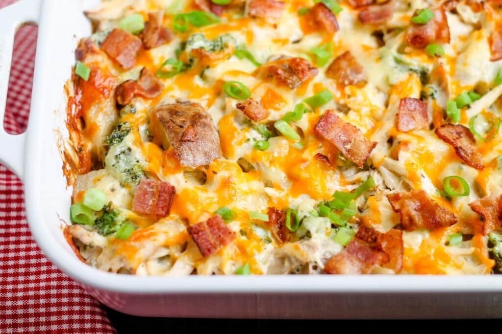 Close-up of loaded chicken potato casserole in a baking dish.