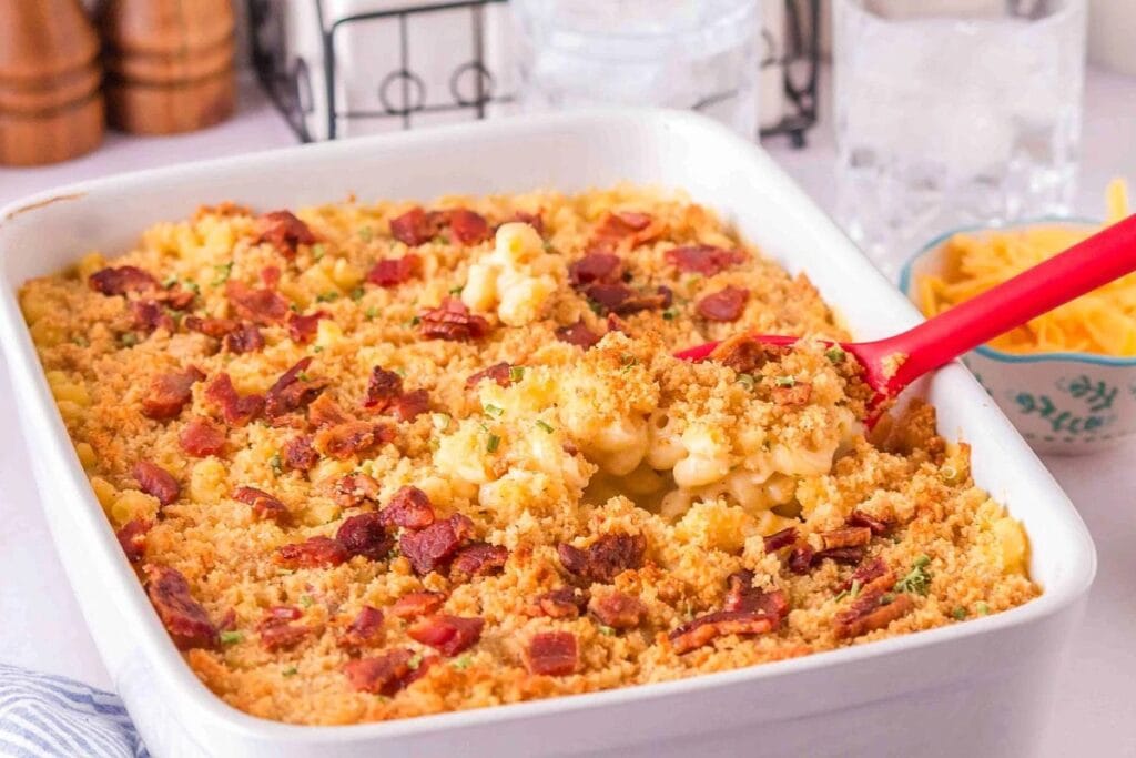 Loaded Mac and Cheese in a baking dish with a serving spoon.
