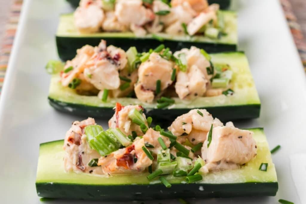 Close-up of lobster salad served in cucumber boats.