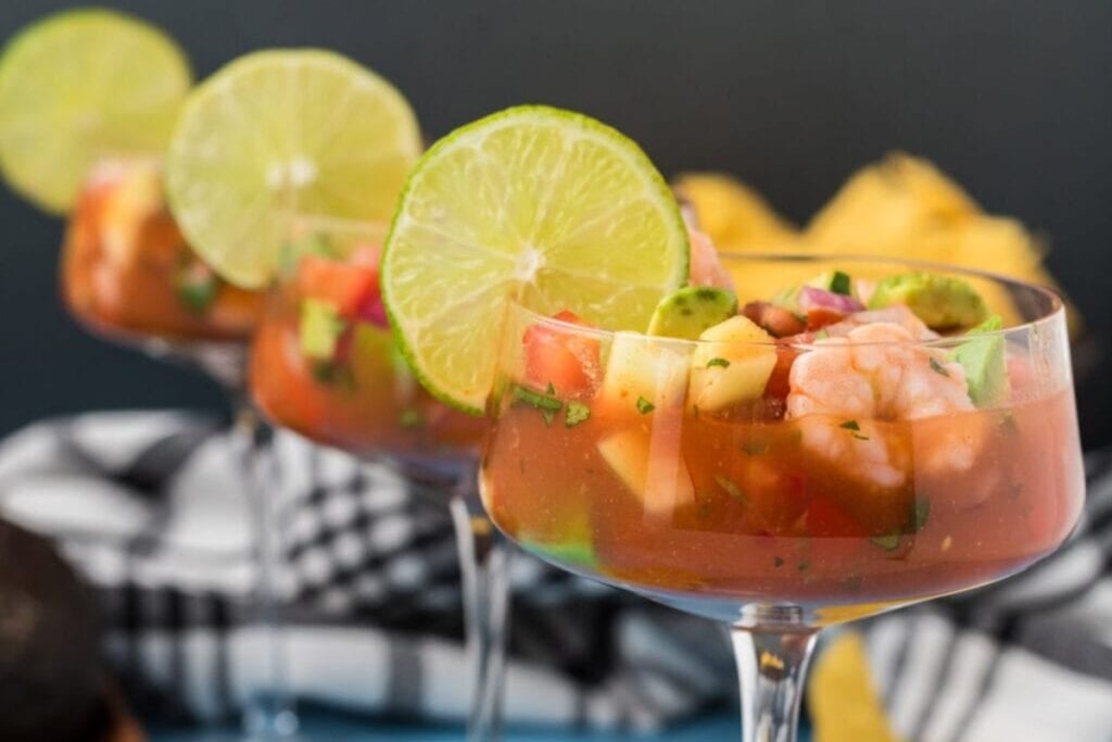 Mexican shrimp cocktail in a glass with sauce and vegetables.