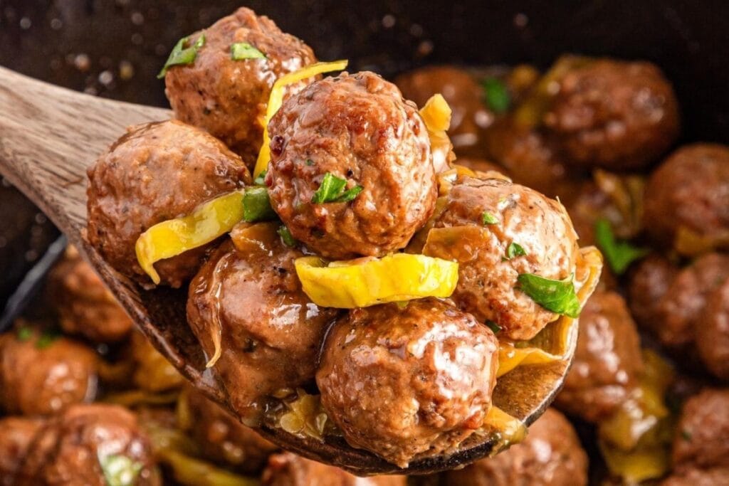 Close-up of Mississippi meatballs on a wooden spoon.