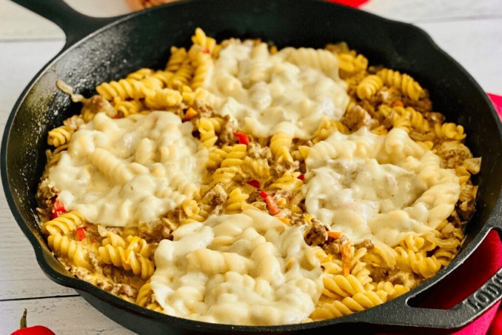 Philly cheesesteak pasta in a skillet.