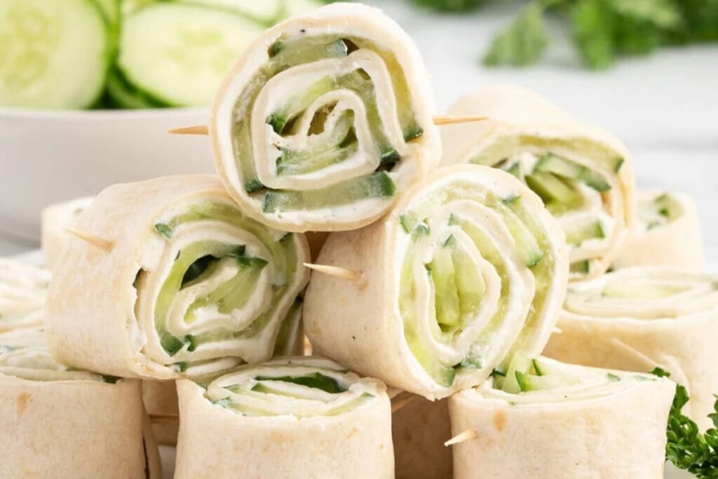 Close-up of appetizer pinwheel sandwiches on a plate.